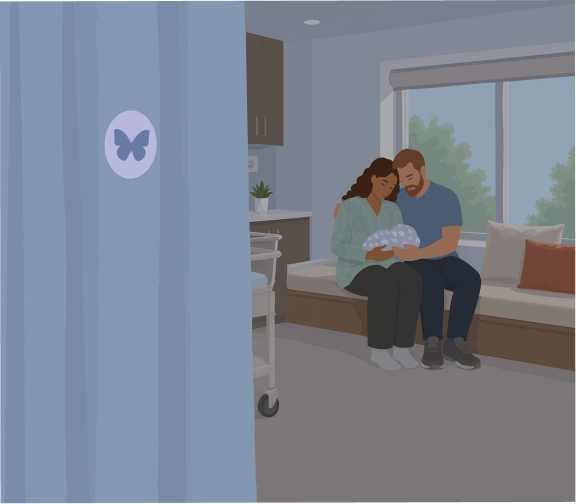 couple holding baby in hospital room